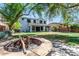 Backyard features a large grassy area with a firepit and covered patio at 567 E Tropical Dr, Casa Grande, AZ 85122