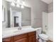 Bathroom with cherry cabinets, sink, and bath tub with shower at 567 E Tropical Dr, Casa Grande, AZ 85122