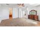 Inviting bedroom space with a ceiling fan, carpeted floors, a closet, and easy access to an attached bathroom at 567 E Tropical Dr, Casa Grande, AZ 85122