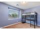 Cozy bedroom showcasing blue walls, carpet, a window with blinds, and a built-in loft bed with a desk at 567 E Tropical Dr, Casa Grande, AZ 85122