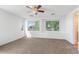Spacious bedroom boasts neutral carpet, recessed lighting, a ceiling fan, and multiple windows for ample natural light at 567 E Tropical Dr, Casa Grande, AZ 85122
