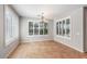 Bright dining room with tile flooring, plantation shutters, and a decorative chandelier at 567 E Tropical Dr, Casa Grande, AZ 85122