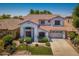 Beautiful two-story home featuring a tile roof, manicured lawn, and an attached two-car garage at 567 E Tropical Dr, Casa Grande, AZ 85122