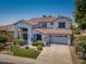 Spacious two-story home featuring a tile roof, a two-car garage, and well-maintained landscaping at 567 E Tropical Dr, Casa Grande, AZ 85122