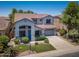 Beautiful two-story home featuring a tile roof, manicured lawn, and an attached two-car garage at 567 E Tropical Dr, Casa Grande, AZ 85122