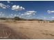Wide desert land with sparse vegetation under a vast, cloudy sky at 567 E Tropical Dr, Casa Grande, AZ 85122