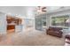 Open-concept living room and kitchen area with stainless steel appliances and a breakfast bar at 567 E Tropical Dr, Casa Grande, AZ 85122