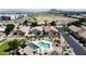 Beautiful aerial view of desert homes with a community pool, solar panels, and mountain backdrop at 5815 E Nora St, Mesa, AZ 85215