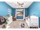 bedroom with blue wall, white trim, and a window that provides natural light at 5815 E Nora St, Mesa, AZ 85215