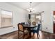 Dining room features a wood table, chandelier, and sliding glass doors to the backyard at 5815 E Nora St, Mesa, AZ 85215