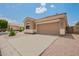 A one-story home featuring a two-car garage and low-maintenance desert landscaping in a quiet neighborhood at 5815 E Nora St, Mesa, AZ 85215
