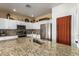 Stylish kitchen with granite countertops, stainless steel appliances, and decorative backsplash at 5815 E Nora St, Mesa, AZ 85215