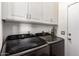 Well-equipped laundry room features a side-by-side washer and dryer, plus handy upper cabinets at 5815 E Nora St, Mesa, AZ 85215