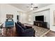 Inviting living room featuring a large TV, hardwood floors, and cozy seating at 5815 E Nora St, Mesa, AZ 85215