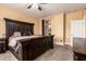 A bedroom with a ceiling fan and a large dark wood bed and matching furniture at 5815 E Nora St, Mesa, AZ 85215