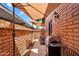 Inviting back patio with outdoor seating, a grill, and shade umbrellas, perfect for entertaining at 6416 S Kenneth Pl # D, Tempe, AZ 85283