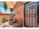 Charming patio area with wicker chairs, a small table, and a security door for peace of mind at 6416 S Kenneth Pl # D, Tempe, AZ 85283