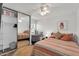 Bedroom with decorative rug, closet with sliding mirror doors, and bright natural light at 6416 S Kenneth Pl # D, Tempe, AZ 85283