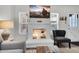 Living room fireplace with decor, flatscreen TV, gray chair and sectional sofa at 6416 S Kenneth Pl # D, Tempe, AZ 85283