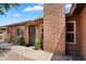 Side angle of a single-story brick home with a covered front entrance and desert landscaping at 6416 S Kenneth Pl # D, Tempe, AZ 85283