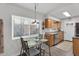 Bright kitchen with updated stainless steel appliances and an adjacent dining area with natural light at 6416 S Kenneth Pl # D, Tempe, AZ 85283