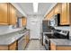 Modern kitchen with stainless steel appliances and granite countertops at 6416 S Kenneth Pl # D, Tempe, AZ 85283