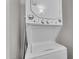 Close-up of a stacked, white, GE washer and dryer with clearly labeled settings and controls at 6416 S Kenneth Pl # D, Tempe, AZ 85283
