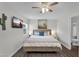 Comfortable main bedroom features neutral decor and ample natural light from a window at 6416 S Kenneth Pl # D, Tempe, AZ 85283