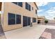 Spacious backyard featuring a large patio, rock landscaping, and a beige two-story home at 6516 E Rochelle St, Mesa, AZ 85215