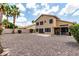 Spacious backyard with rock landscaping, covered patio with grill, and lush green bushes at 6516 E Rochelle St, Mesa, AZ 85215