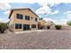 Expansive backyard with rock landscaping, patio, and covered outdoor kitchen perfect for entertaining at 6516 E Rochelle St, Mesa, AZ 85215