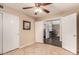 Neutral-toned room with tile flooring, double doors and a ceiling fan with light at 6516 E Rochelle St, Mesa, AZ 85215