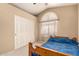 Inviting bedroom featuring soft lighting and an arched window; perfect for relaxation at 6516 E Rochelle St, Mesa, AZ 85215