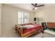 Bright bedroom featuring a ceiling fan and window shutters; nice natural light at 6516 E Rochelle St, Mesa, AZ 85215