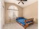 Cozy bedroom featuring a vaulted ceiling, arched window, and a comfortable bed at 6516 E Rochelle St, Mesa, AZ 85215