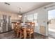 Dining room features a wooden table and chairs next to the stainless steel refrigerator at 6516 E Rochelle St, Mesa, AZ 85215