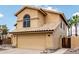 View of a two-story home with a tile roof and desert landscaping, showcasing Southwestern architectural style at 6516 E Rochelle St, Mesa, AZ 85215