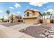 Charming home with a desert-style rock garden, palm trees, and a stucco exterior, for a low-maintenance look at 6516 E Rochelle St, Mesa, AZ 85215