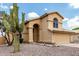 Two-story home with arched entryway and double garage, complemented by desert landscaping with native cacti at 6516 E Rochelle St, Mesa, AZ 85215