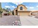 Inviting two-story home with a neutral stucco exterior, rock landscaping, and a tile roof for a stylish look at 6516 E Rochelle St, Mesa, AZ 85215