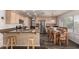 Well-lit kitchen showcases stainless steel appliances, wood floors, and breakfast bar seating at 6516 E Rochelle St, Mesa, AZ 85215