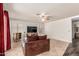 Bright living room features tile floors, ceiling fan, entertainment center, and neutral paint at 6516 E Rochelle St, Mesa, AZ 85215