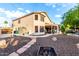 Spacious backyard with a covered patio, lush landscaping, and a cozy fire pit area at 7029 E Monte Cir, Mesa, AZ 85209