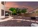 Relaxing backyard featuring a covered patio with dining, comfortable lounge chairs, and rock landscaping at 7029 E Monte Cir, Mesa, AZ 85209