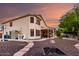Expansive backyard with a covered patio, lush landscaping, and a cozy fire pit area at 7029 E Monte Cir, Mesa, AZ 85209