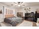 The bedroom features a ceiling fan, white shutter blinds, neutral walls, and a queen-sized bed with grey bedding at 7029 E Monte Cir, Mesa, AZ 85209