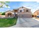 Two-story home featuring a three-car garage, stone accents, and well-manicured lawn at 7029 E Monte Cir, Mesa, AZ 85209