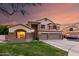 Charming two-story home with a three-car garage and stone accents at 7029 E Monte Cir, Mesa, AZ 85209