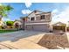 Spacious two-story home with a three-car garage, stone accents, and driveway at 7029 E Monte Cir, Mesa, AZ 85209
