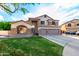 Stunning two-story home featuring stone accents, a three-car garage, and well-maintained landscaping at 7029 E Monte Cir, Mesa, AZ 85209